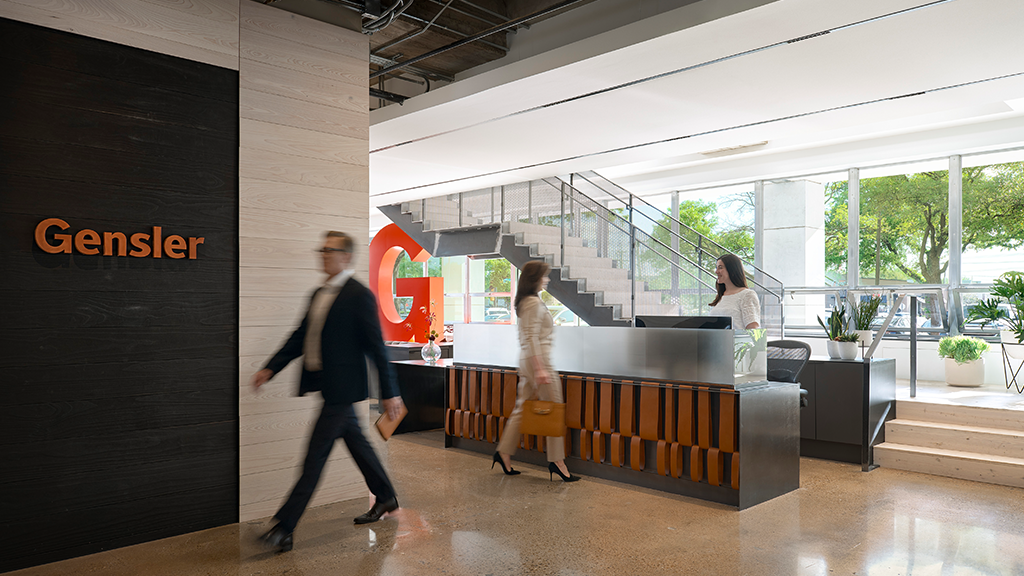 A few people walking in a building.